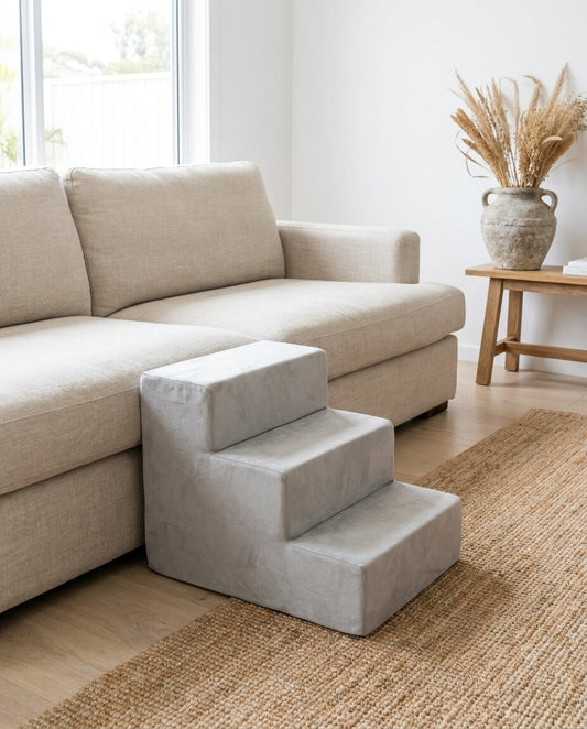 The Steps three-step foam pet stairs beside a linen sofa | PawHaus Co |s:3-steps